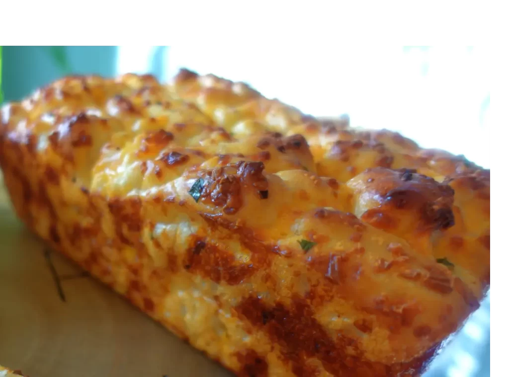 loaf of baked chopped garlic cheese bread