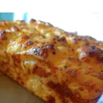 loaf of baked chopped garlic cheese bread