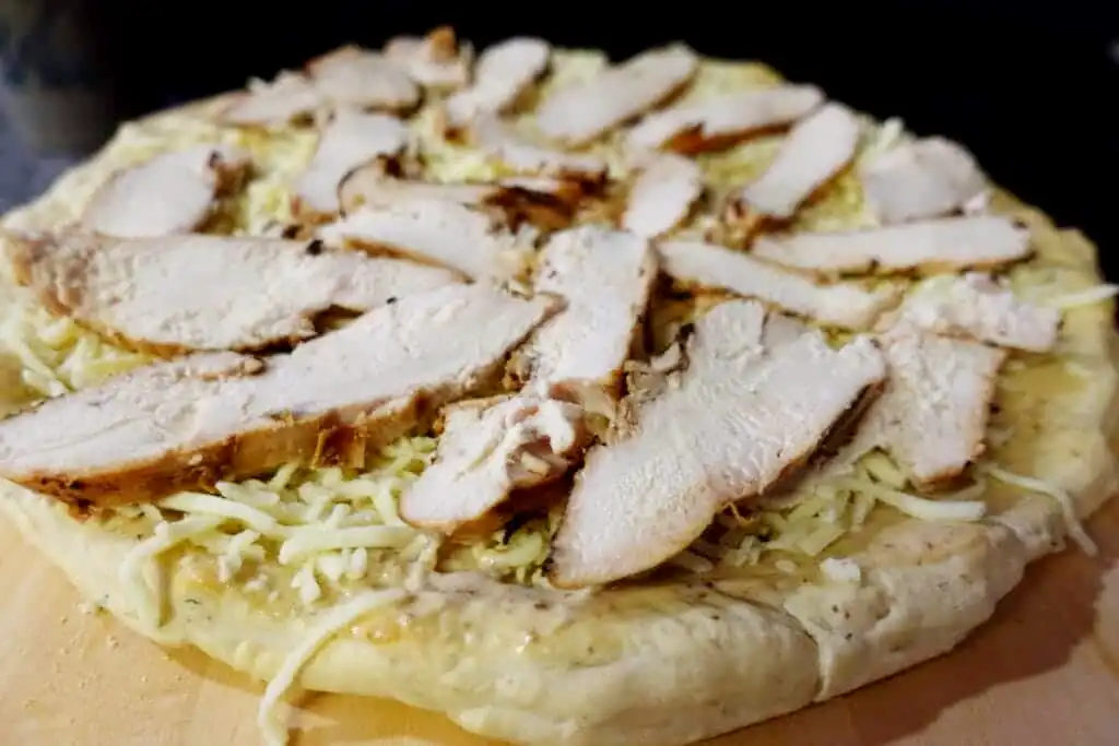 pizza-crust-with-mozzarella-and-chicken-ready-for-baking