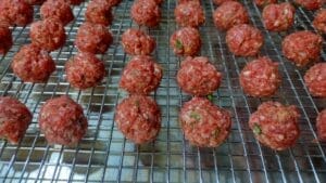 meatballs on rack on cookie sheet