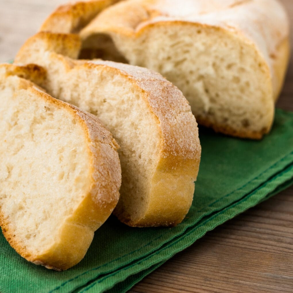 french bread on a green napkin sliced