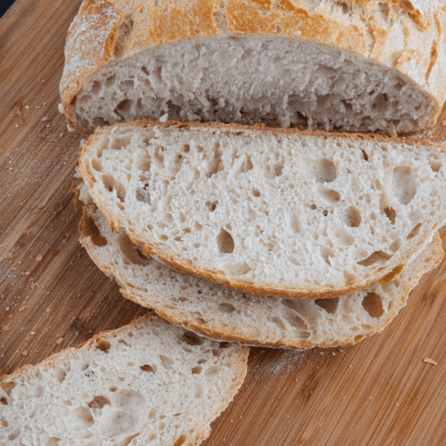 no knead bread sliced on cutting board