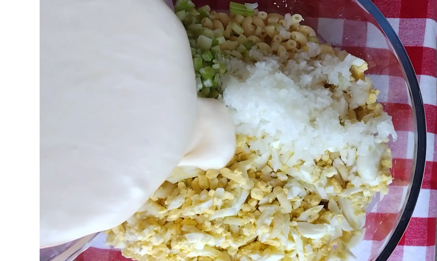 pouring-dressing-on-macaroni-salad
