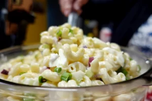 spoonful-of-macaroni-salad-being-scooped-out-of-serving-bowl.