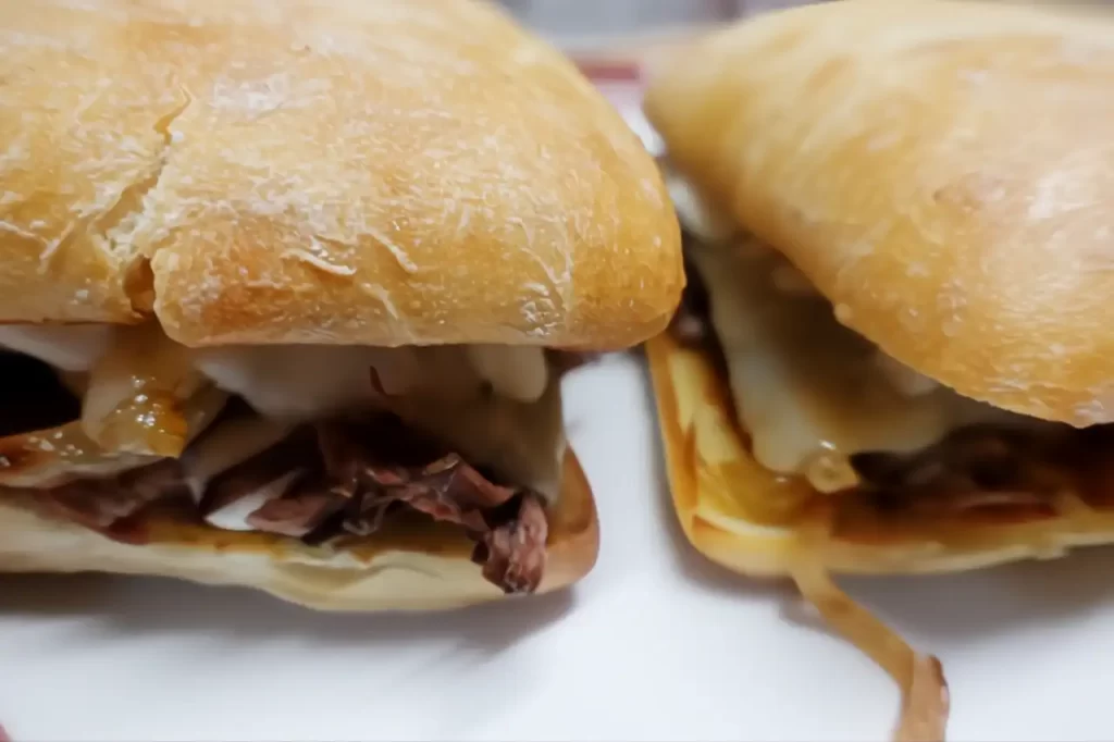 2-ciabatta-onion-beef-bombs-on-white-plate.