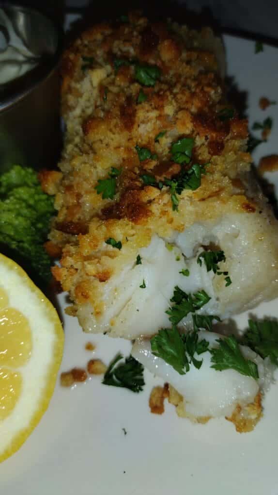 baked haddock on plate with lemon