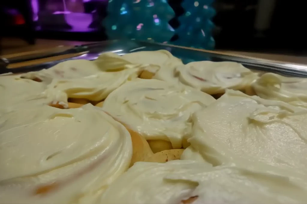 side-view-cinnamon-rolls-iced-in-pan