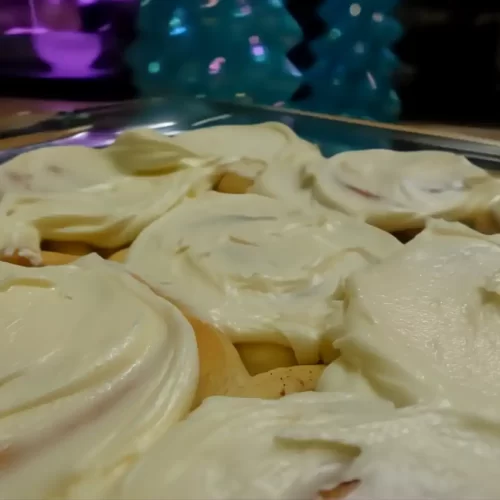 side-view-cinnamon-rolls-iced-in-pan