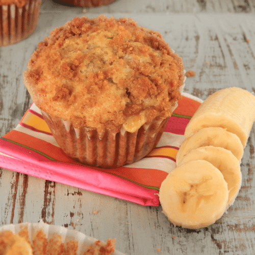 Banana Muffin on pink striped napkin with sliced banana