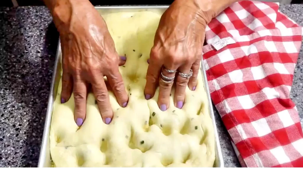 pressing-dimples-into-focaccia-bread