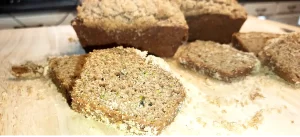 zucchini-bread-loaves-and-slicces-on-wooden-cutting-board-