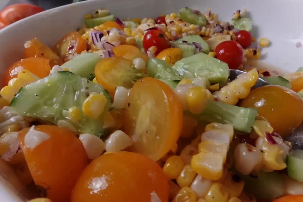 Easy-grilled-corn-salad-with-charred-sweet-corn-cherry-tomatoes-fresh-cucumber-sweet-onionin-a-light-honey-vinaigrette.