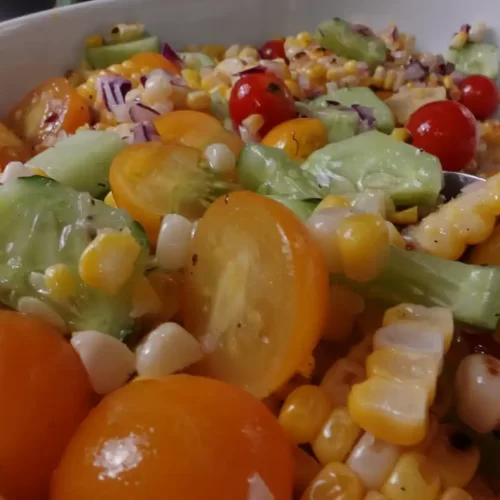 Easy-grilled-corn-salad-with-charred-sweet-corn-cherry-tomatoes-fresh-cucumber-sweet-onionin-a-light-honey-vinaigrette.