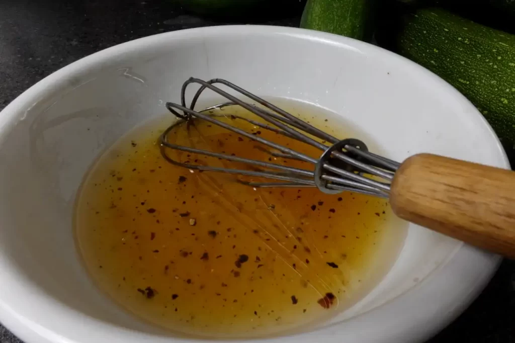 Honey-vinaigrette-dressing-made-with-olive-oil-white-wine-vinegar-honey-salt-and-pepper-for-an-easy-grilled-corn-salad-recipe.