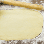 bread dough rolled into rectangle shape with a rolling pin