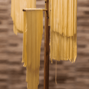 homemade pasta drying on rack