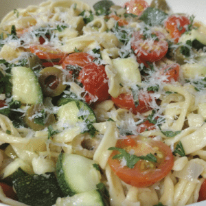 pasta with zuccini and cherry tomatoes tossed in white wine sauce.