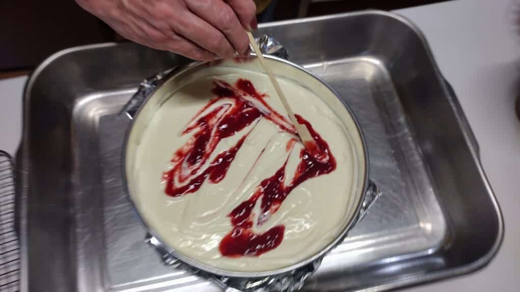 swirling cherry puree into cheesecake batter