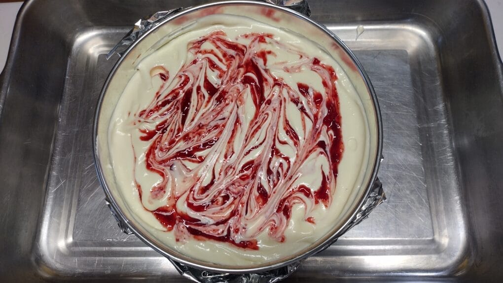 cherry puree swirled on cheesecake