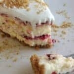 slice of cherry swirl cheesecake on white plate with a fork