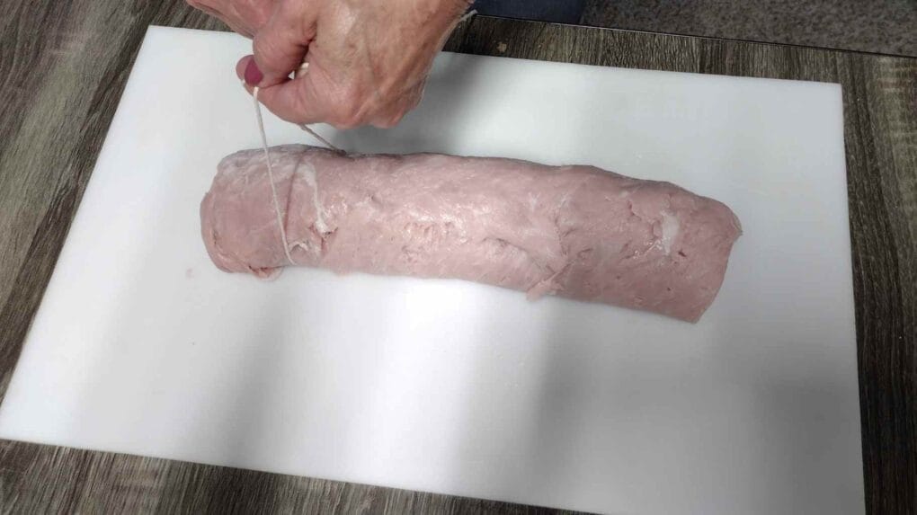 tying a pork loin roll