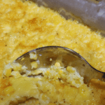 baked corn in a baking dish with spoon