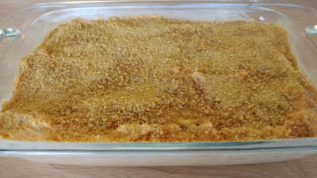 savory sweet potato bake before being baked in clear glass dish