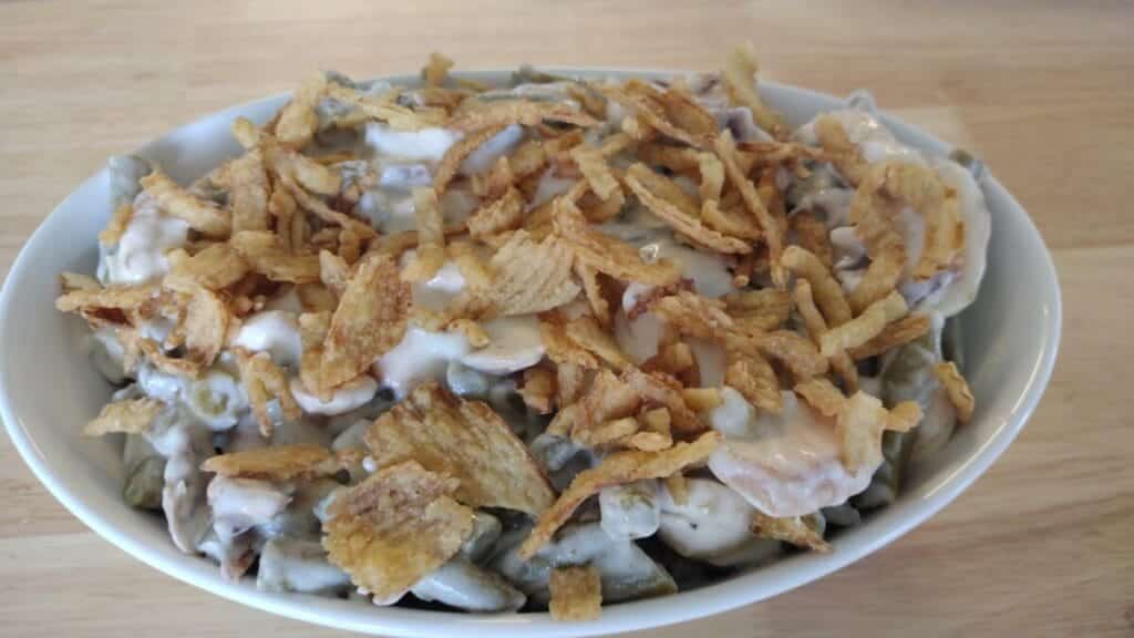 green bean casserole with french's onions in white serving dish