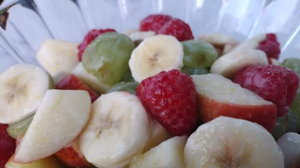 lemon glazed fruit salad bananas, apples, raspberries and green grapes