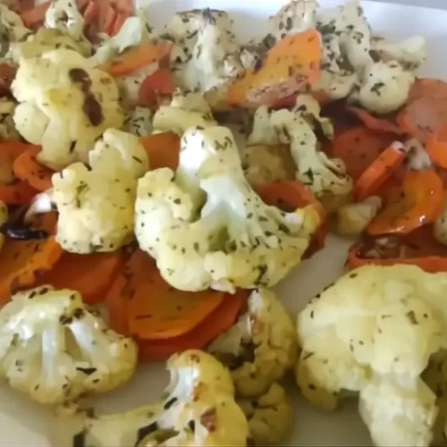 roasted cauliflower and carrots on white serving tray