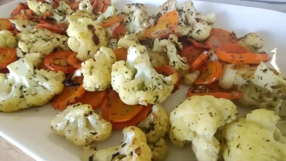 roasted cauliflower and carrots on white serving tray