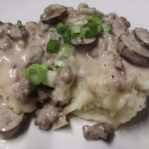 hamburg gravy served over mashed potatoes with green onion garnished with