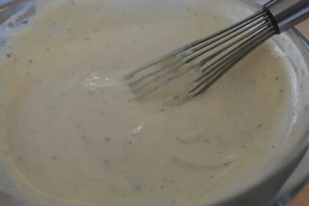 veggie dip in mixing bowl with whisk