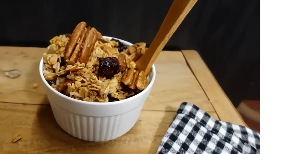 granola-in-small-white-bowl-with-wooden-spoon