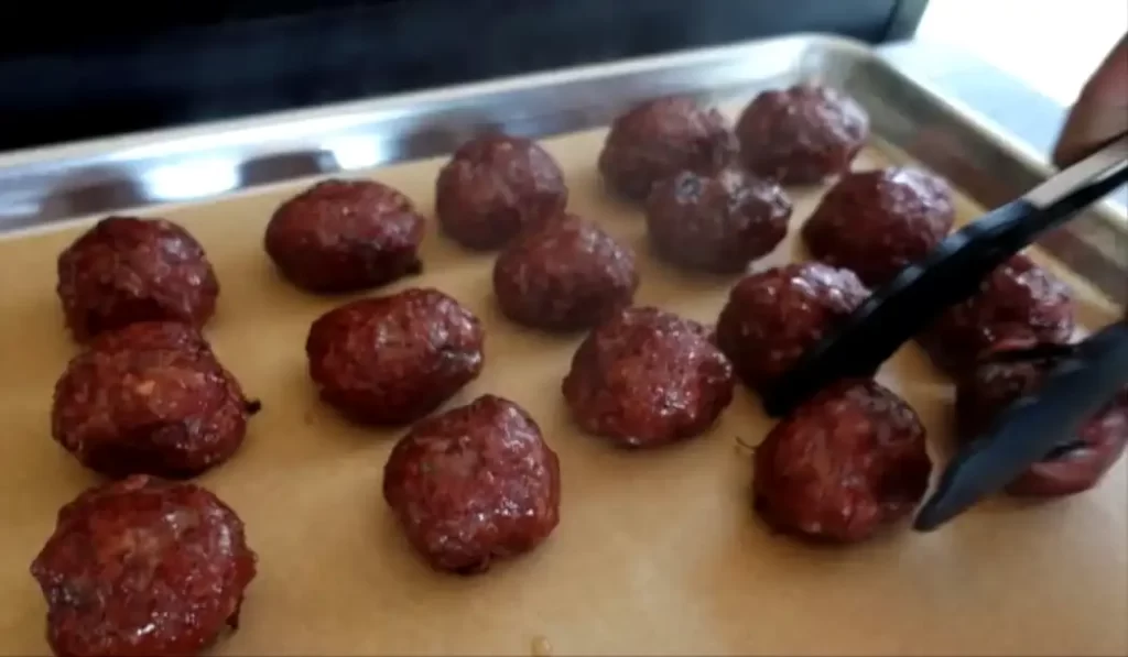 smoked-meatballs-being-taken-off-the-grill