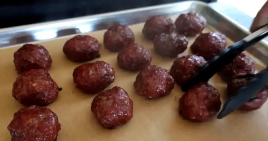 smoked-meatballs-being-taken-off-the-grill