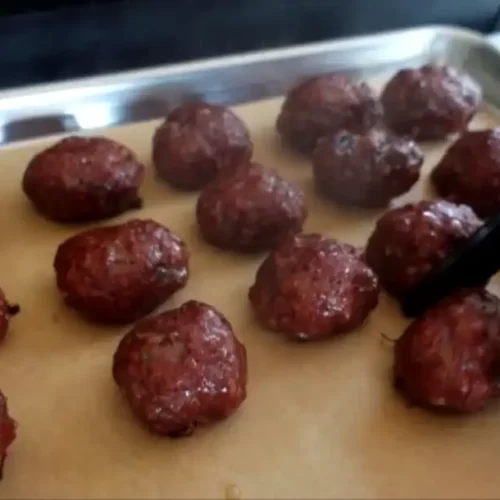 smoked-meatballs-being-taken-off-the-grill