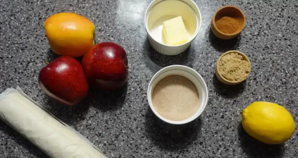 ingredients for apple puff pastry  puff pastry dough, apples cinnamon, sugar lemon and cinnamon