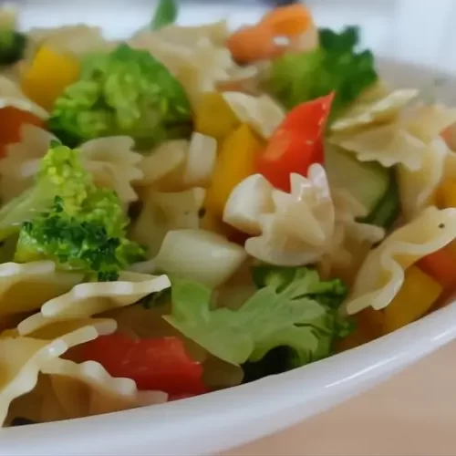 vegetable pasta salad in white serving bowl