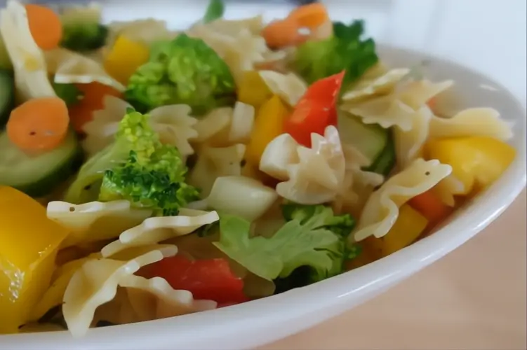 vegetable pasta salad in white serving bowl