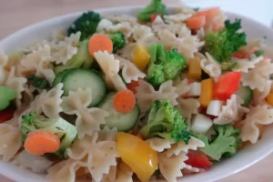 vegetable pasta salad looking down in a white serving dish
