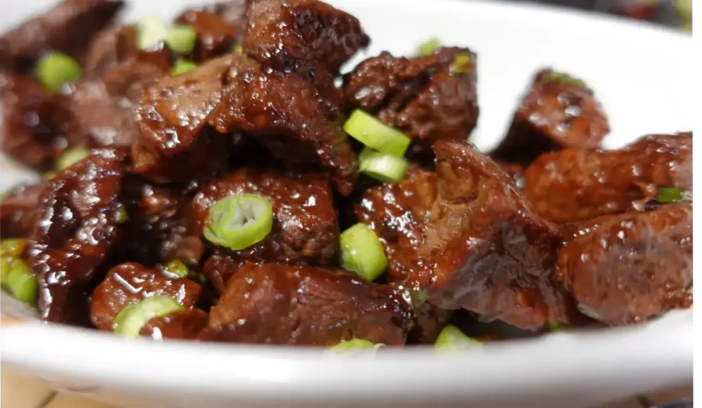 sweet and spicy beef bites on white plate