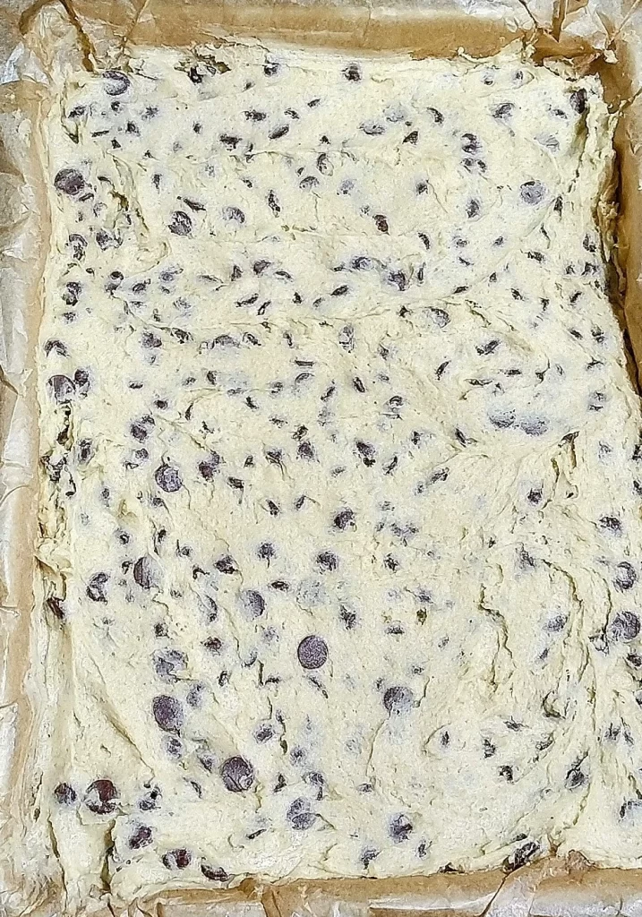 chocolate chip dough spread in a 9 x 13 pan