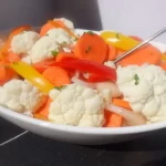 pickled veggies in white bowl: cauliflower, peppers, carrots and onions