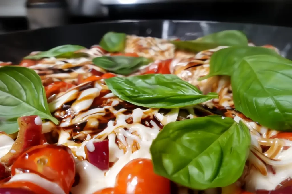 chicken caprese side shot in cast iron skillet