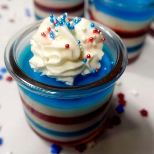 jello cups with whipped topping and sprinkles