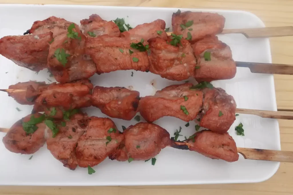 pork kabobs grilled served on white plate