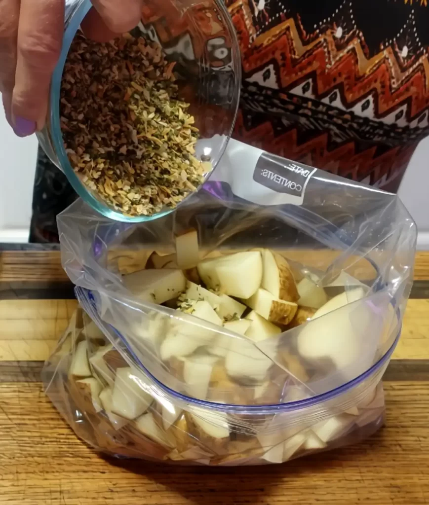 seasoning french onion roasted potatoes in gallon plastic bag