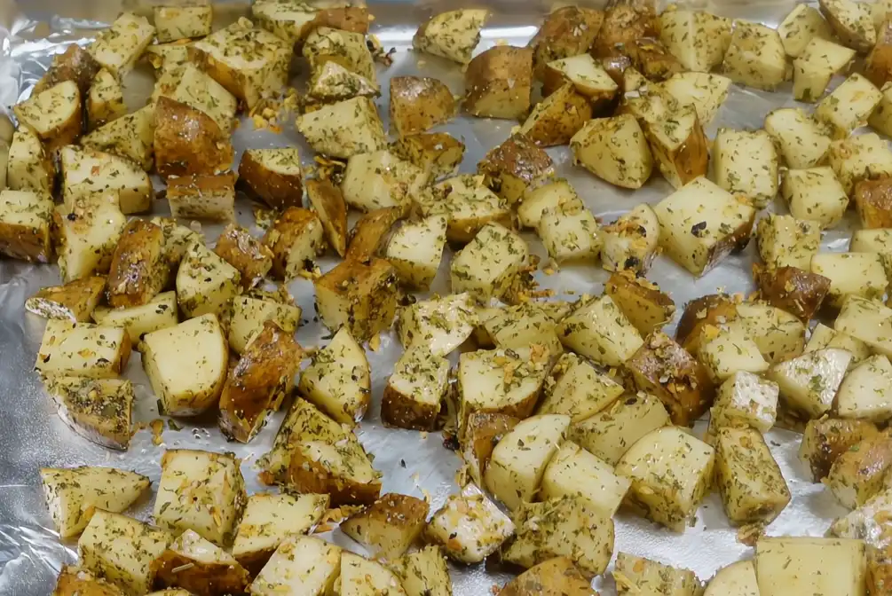 french onion roasted potatoes on a sheet pan ready for the oven