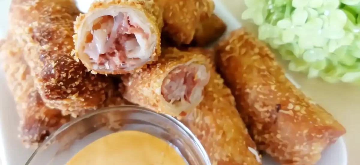 reuben rolls on white plate with dipping sauce